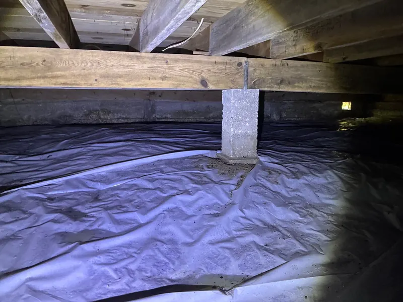 Before: a crawl space with torn plastic on the dirt floor, then a sealed white liner across the floor and walls